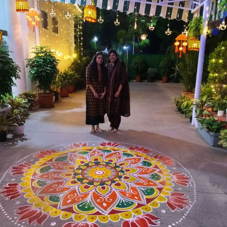 Rajni Dutta, India's best rangoli artist, creating an intricate and colorful floral rangoli design during a cultural event.