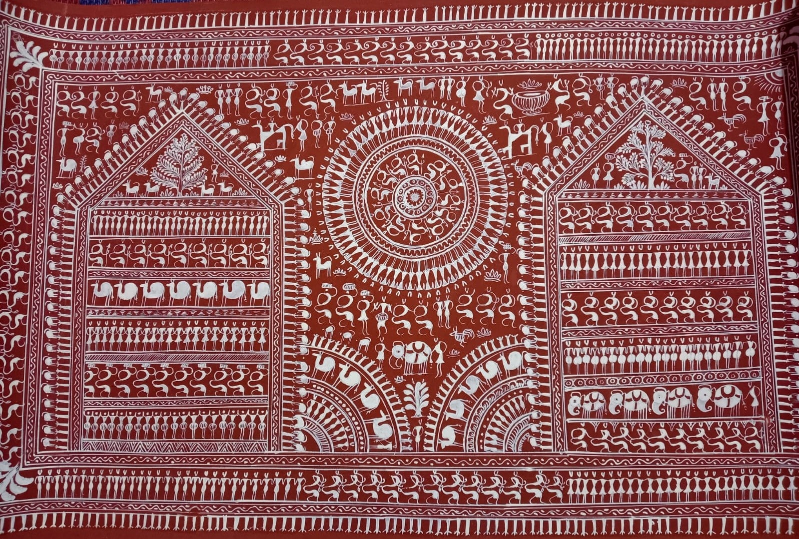 A traditional Warli painting with tribal motifs and geometric patterns